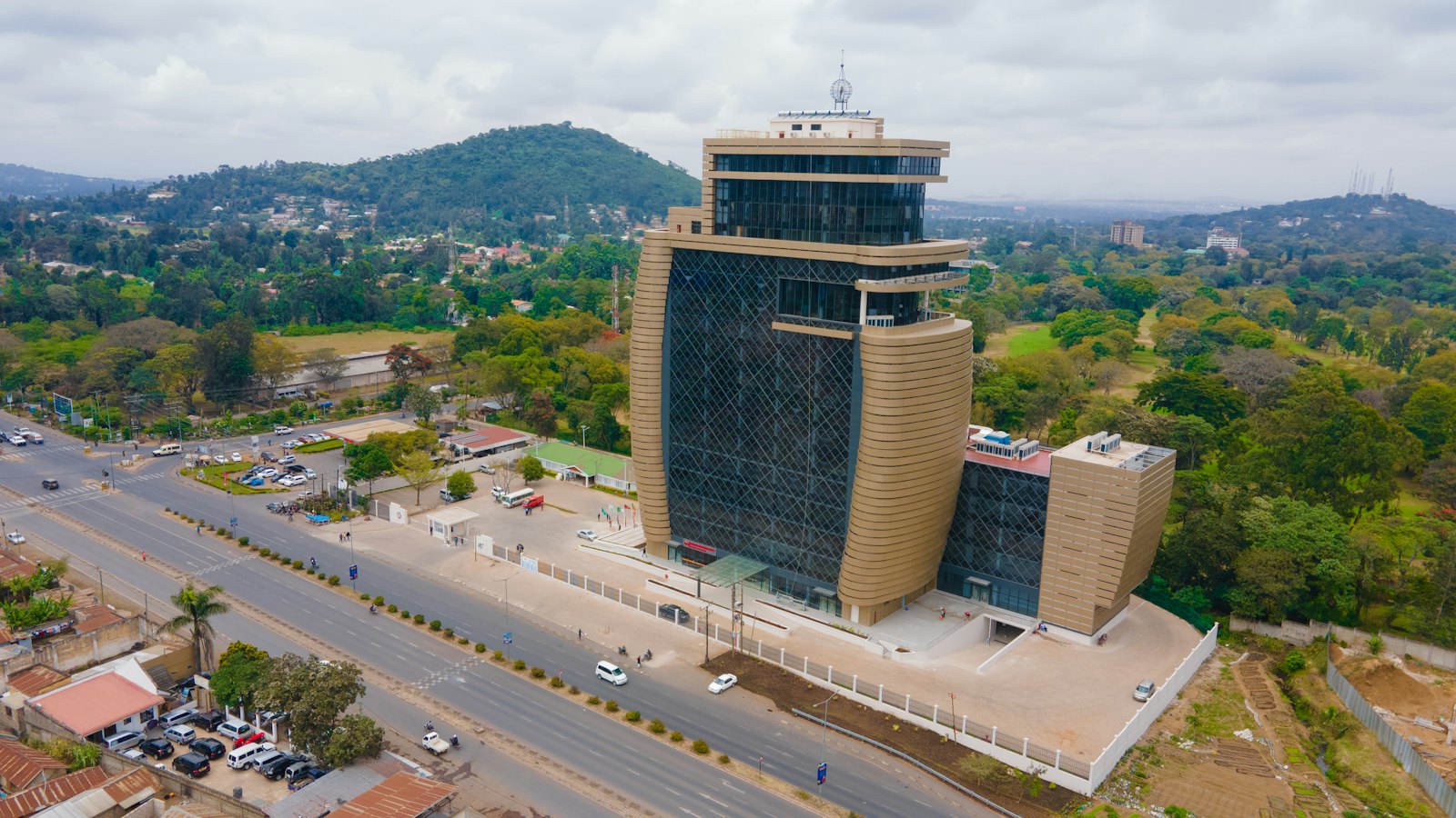 Aerial view of a modern public office building surrounded by trees
