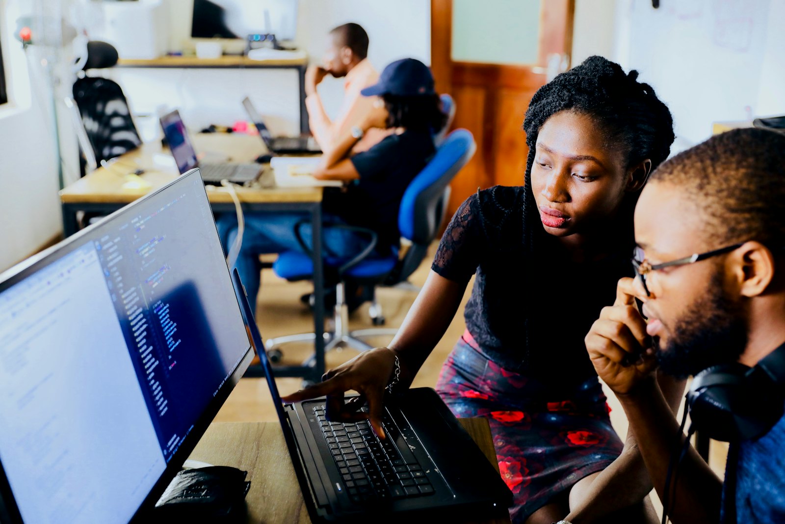 Two engineers reviewing code together at a workstation